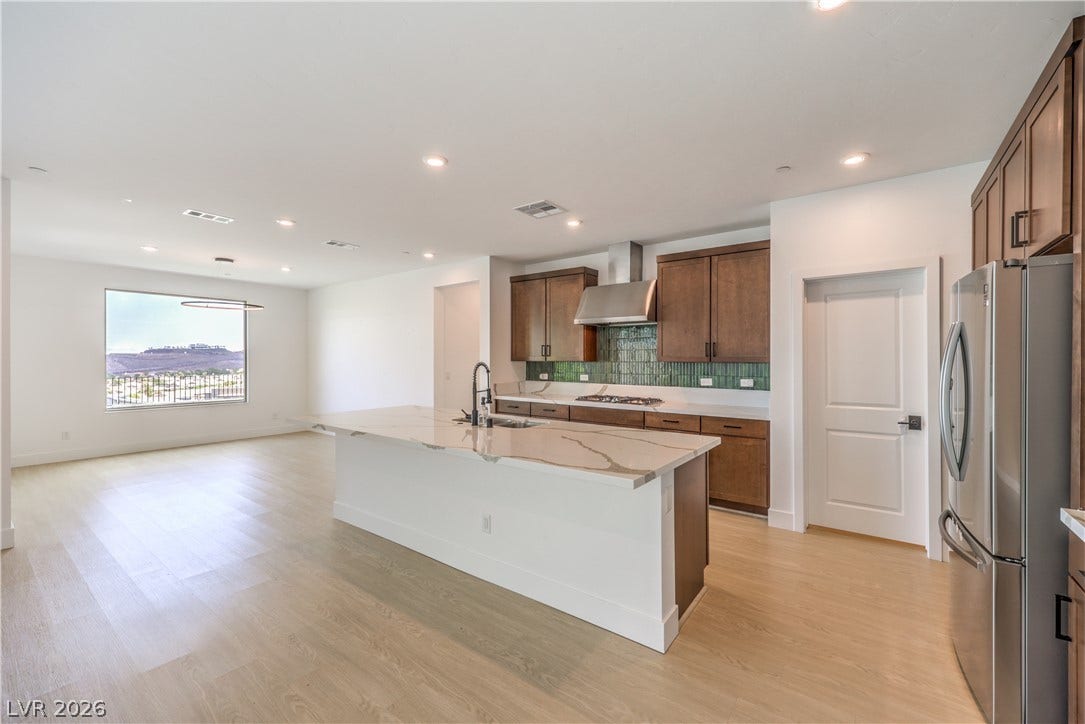 1984 Canyon Highlands Drive, Henderson, NV 89052 An open-concept living space boasts a gourmet kitchen island, high ceilings, and panoramic views.