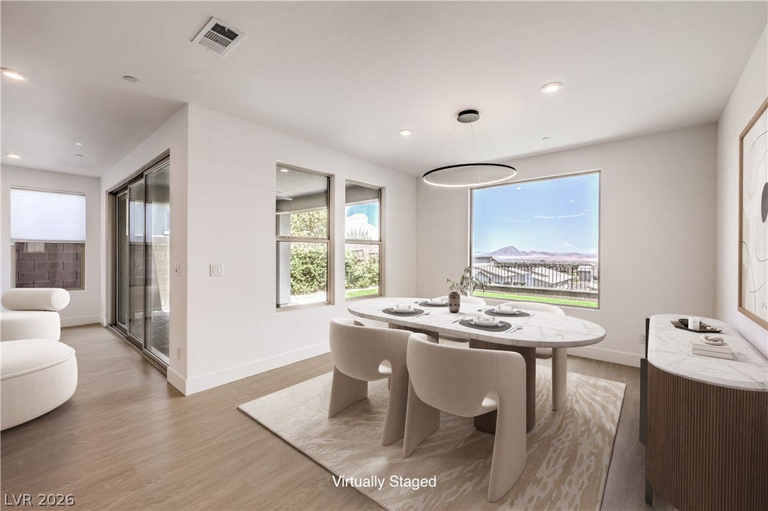 1984 Canyon Highlands Drive, Henderson, NV 89052 A well-lit dining area offers ample space for entertaining with an impressive mountain view.