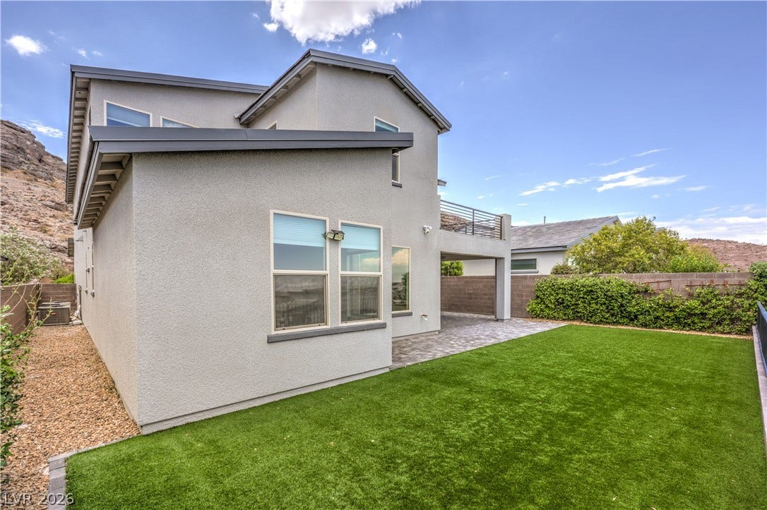 1984 Canyon Highlands Drive, Henderson, NV 89052 A private yard with lush artificial turf and a paved patio area offers an ideal setting for outdoor enjoyment.