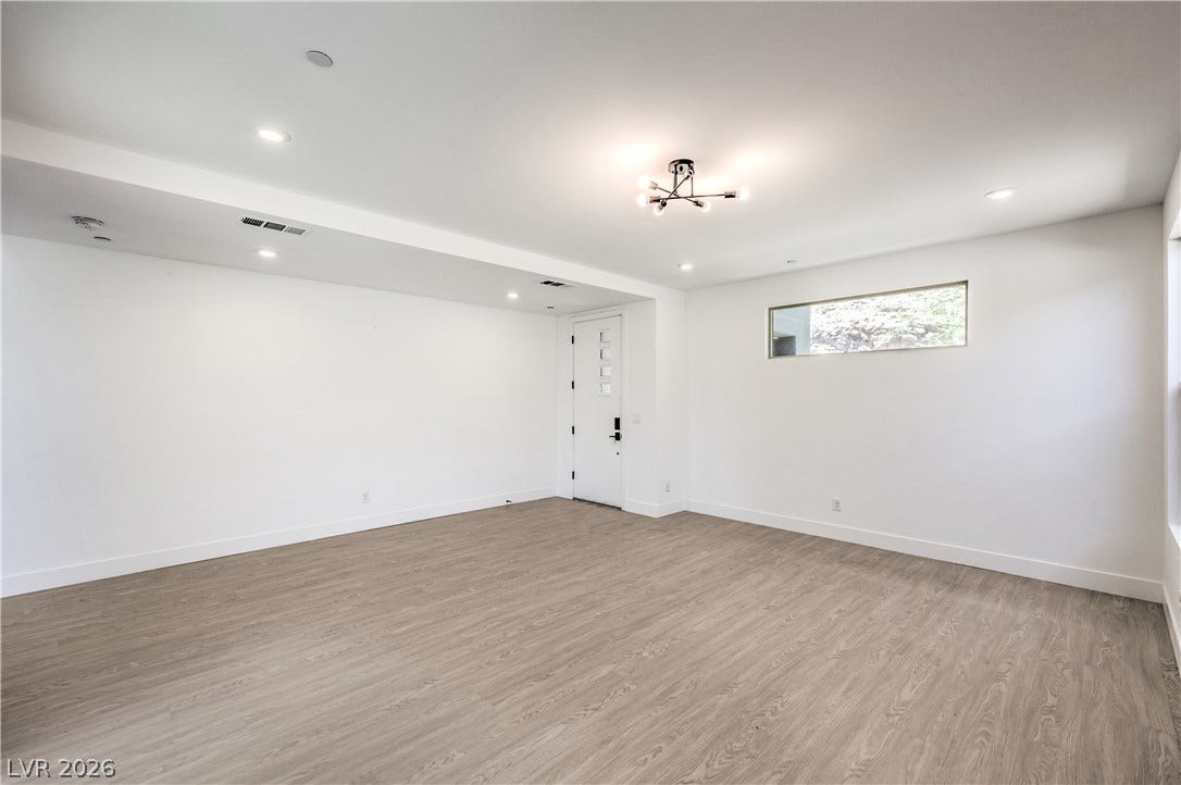 1984 Canyon Highlands Drive, Henderson, NV 89052 A versatile living space features modern lighting, sleek flooring, and a distinctive entryway.