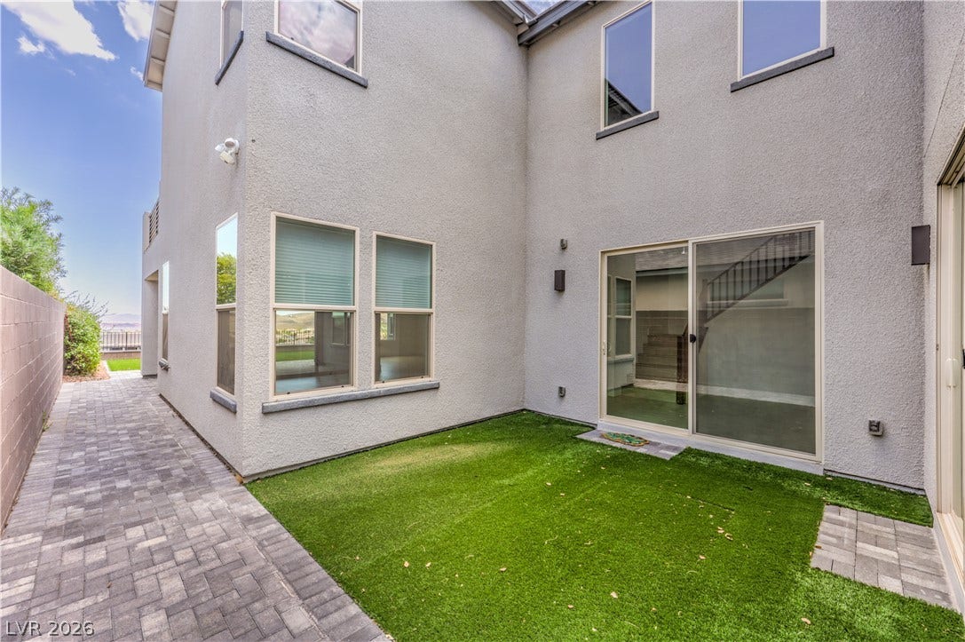 1984 Canyon Highlands Drive, Henderson, NV 89052 A quaint side yard space features artificial turf and a paved walkway leading to the home's rear entrance.