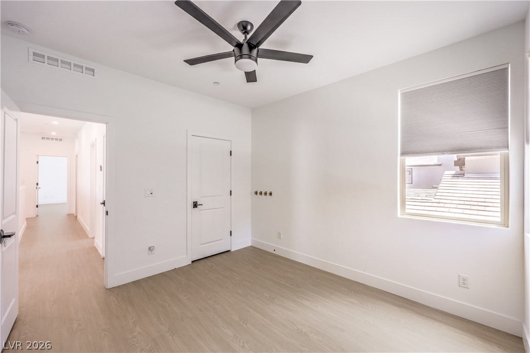 1984 Canyon Highlands Drive, Henderson, NV 89052 A well-lit bedroom featuring light wood flooring and a modern ceiling fan for comfort.