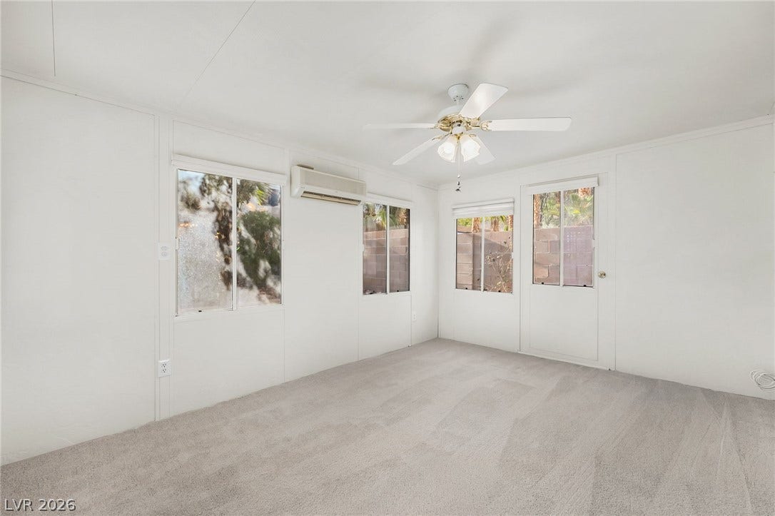 62 Tidwell Lane, Henderson, NV 89074 Plush carpeting and multiple windows anchor this versatile, light-filled living area.