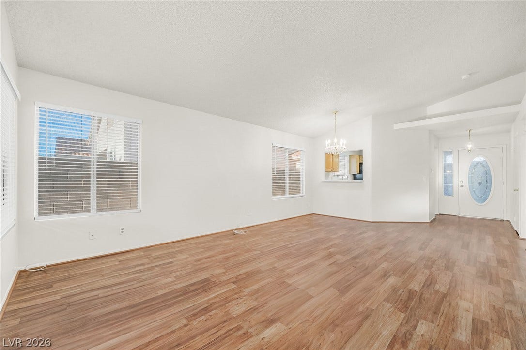62 Tidwell Lane, Henderson, NV 89074 Rich wood-patterned flooring spans this open living space connected to a bright dining area.