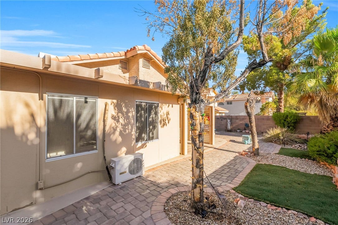 62 Tidwell Lane, Henderson, NV 89074 Paved walkways wind through the low-maintenance yard alongside the stucco exterior.
