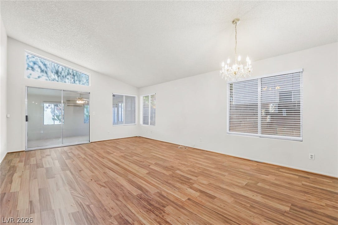 62 Tidwell Lane, Henderson, NV 89074 Angled high ceilings and warm wood floors define this versatile open living space.