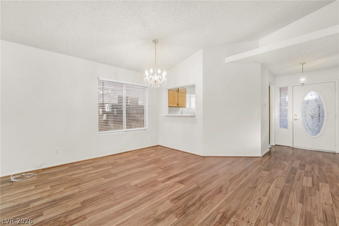 62 Tidwell Lane, Henderson, NV 89074 Rich wood-inspired flooring pairs beautifully with crisp white walls in this open dining area.