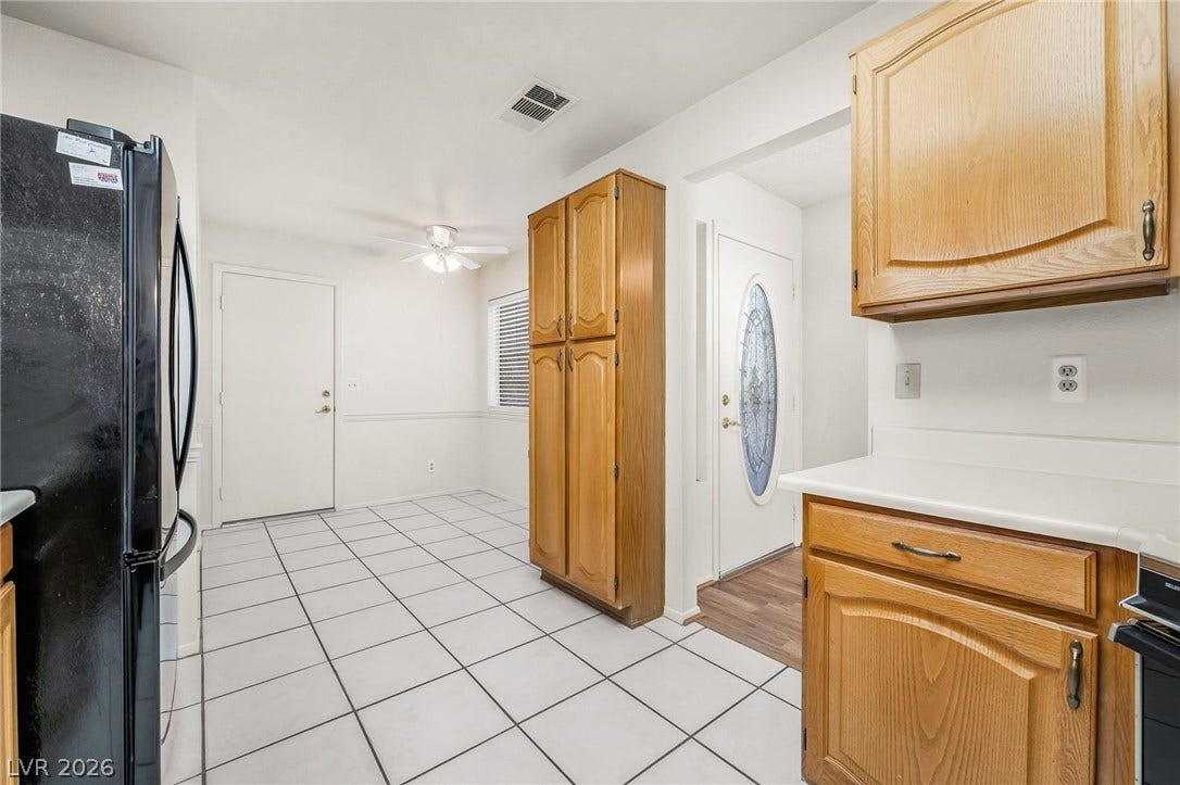 62 Tidwell Lane, Henderson, NV 89074 Tiled flooring and natural wood cabinetry connect the kitchen and casual dining area.
