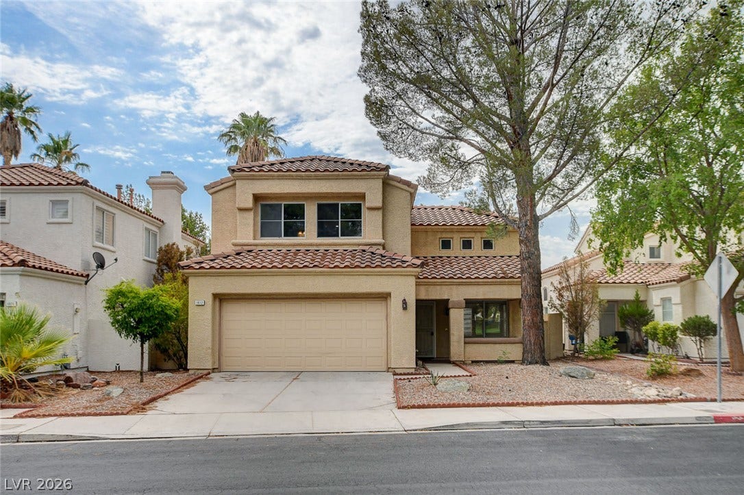 1612 Country Hollow Drive, Las Vegas, NV 89117 A charming stucco exterior home with a terracotta tile roof and an attached garage awaits.