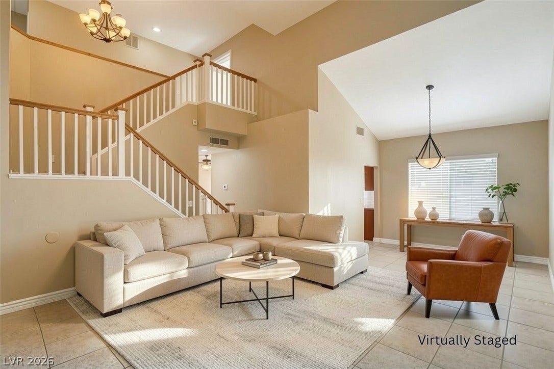 1612 Country Hollow Drive, Las Vegas, NV 89117 Grand two-story living area features a graceful staircase, vaulted ceilings, and abundant natural light.
