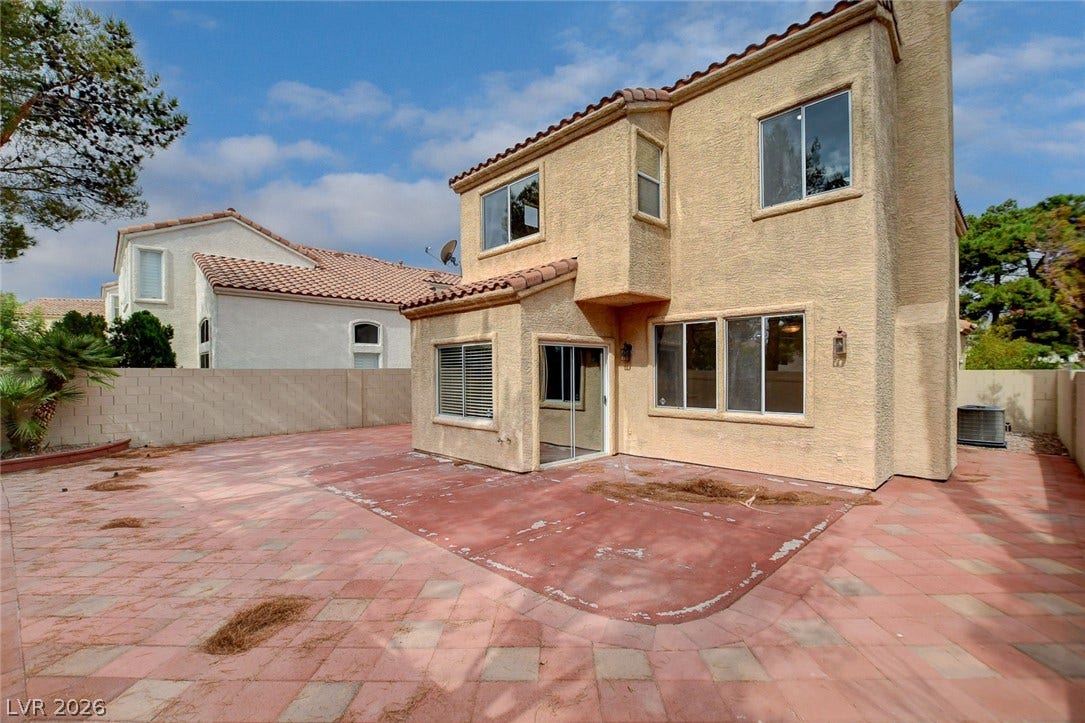 1612 Country Hollow Drive, Las Vegas, NV 89117 A spacious tiled patio offers ample outdoor living space behind this two-story residence.