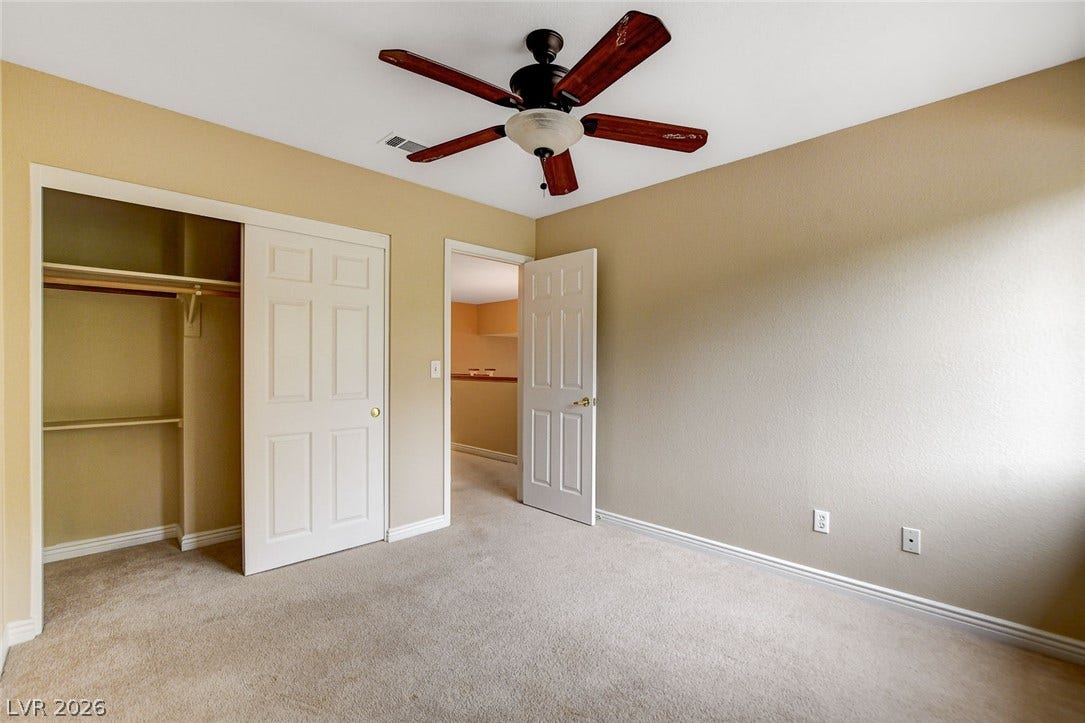 1612 Country Hollow Drive, Las Vegas, NV 89117 An inviting room features a functional ceiling fan and a convenient closet for storage.
