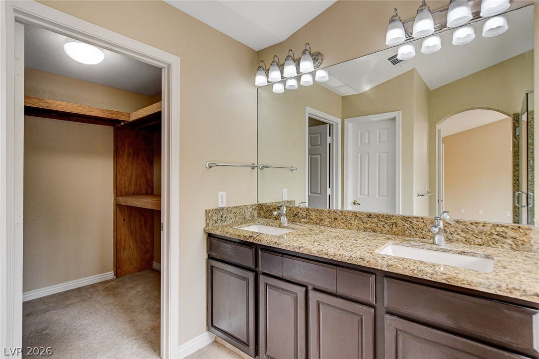 1612 Country Hollow Drive, Las Vegas, NV 89117 Double vanity with granite counters offers abundant space for daily routines.