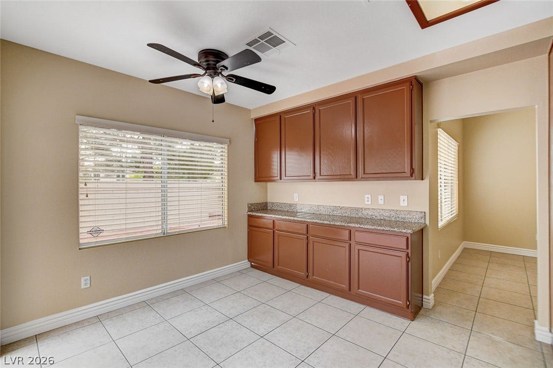 1612 Country Hollow Drive, Las Vegas, NV 89117 Ample cabinetry with stone counters provides efficient storage in this well-appointed utility space.