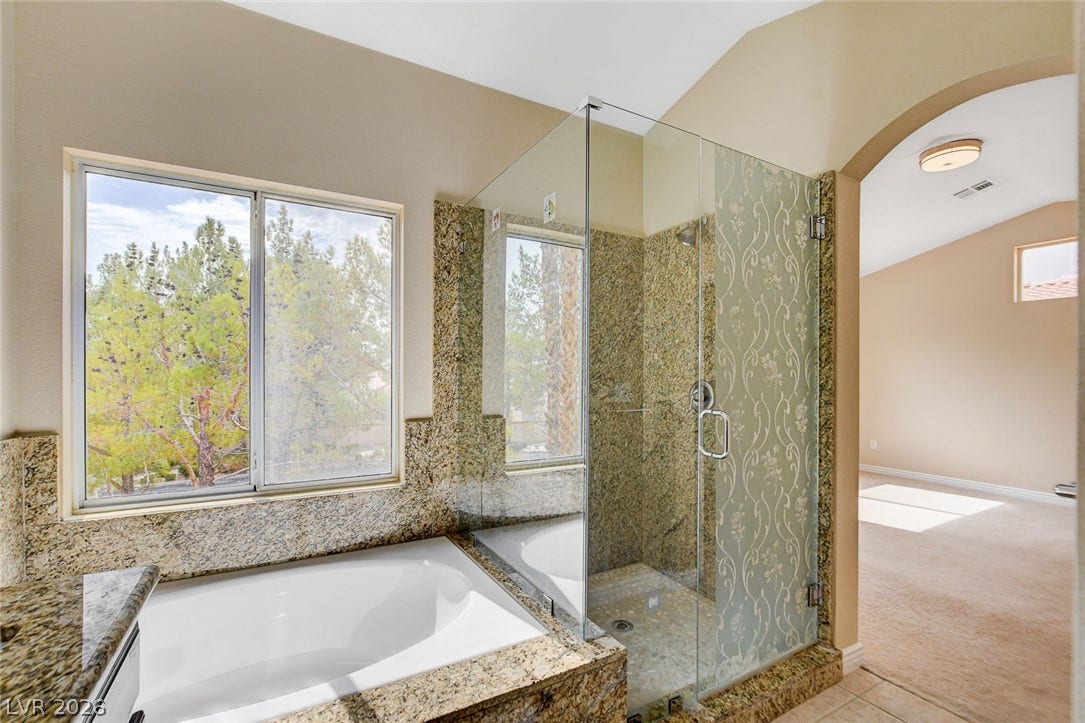 1612 Country Hollow Drive, Las Vegas, NV 89117 Luxurious bath with an elegant shower and relaxing soaking tub.