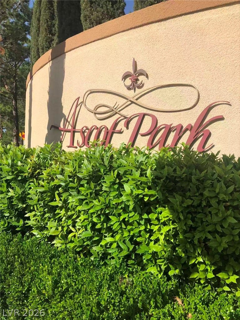 1612 Country Hollow Drive, Las Vegas, NV 89117 Lush green hedges frame the classic stucco monument sign welcoming residents to the neighborhood.