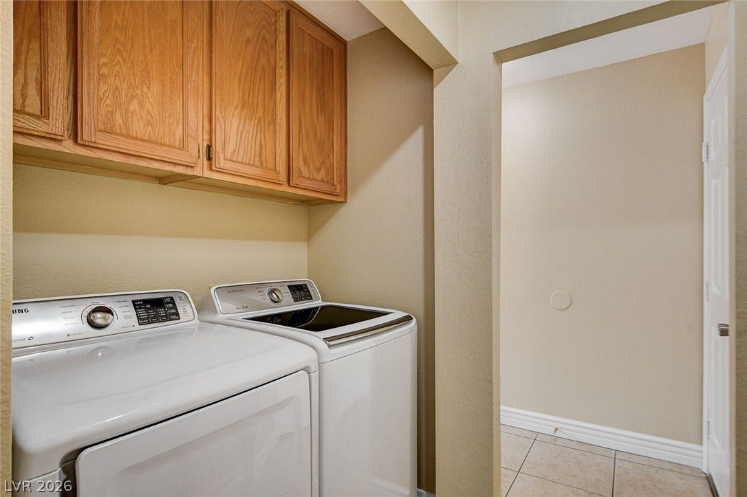 1612 Country Hollow Drive, Las Vegas, NV 89117 Functional laundry area featuring convenient cabinetry and durable tile flooring for easy maintenance.