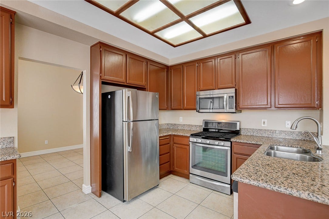 1612 Country Hollow Drive, Las Vegas, NV 89117 A well-appointed culinary space featuring sleek stainless steel appliances and abundant cabinetry.