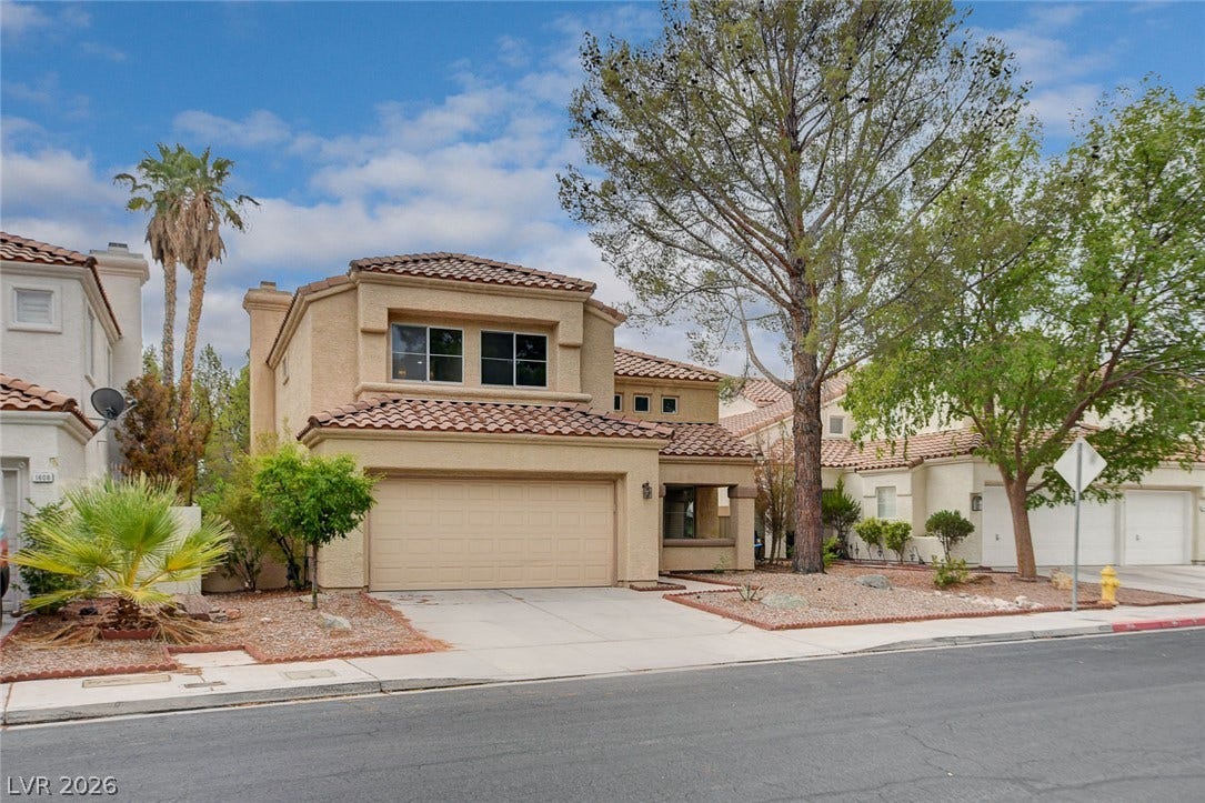 1612 Country Hollow Drive, Las Vegas, NV 89117 A spacious home with a two-car garage features a tile roof and desert-friendly landscaping.