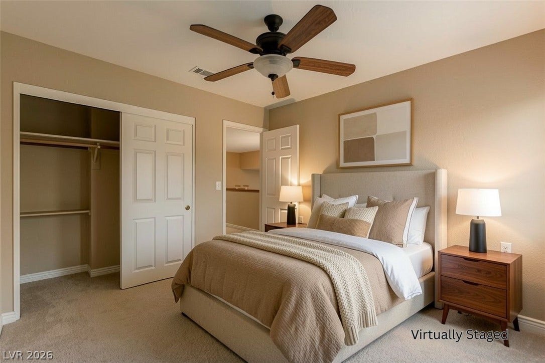 1612 Country Hollow Drive, Las Vegas, NV 89117 A comfortable bedroom with a warm, inviting atmosphere, featuring a ceiling fan and plush carpet.