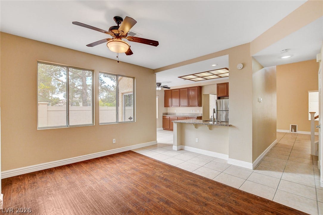 1612 Country Hollow Drive, Las Vegas, NV 89117 An open-concept living space seamlessly transitions from rich wood flooring to tiled kitchen with a breakfast bar.