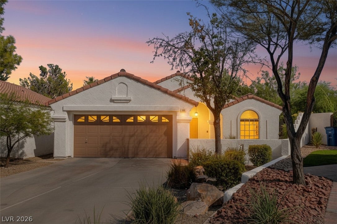 236 Misty Garden Street, Henderson, NV 89012 Spanish tile roofing and a smooth stucco exterior define this classic single-level desert home.