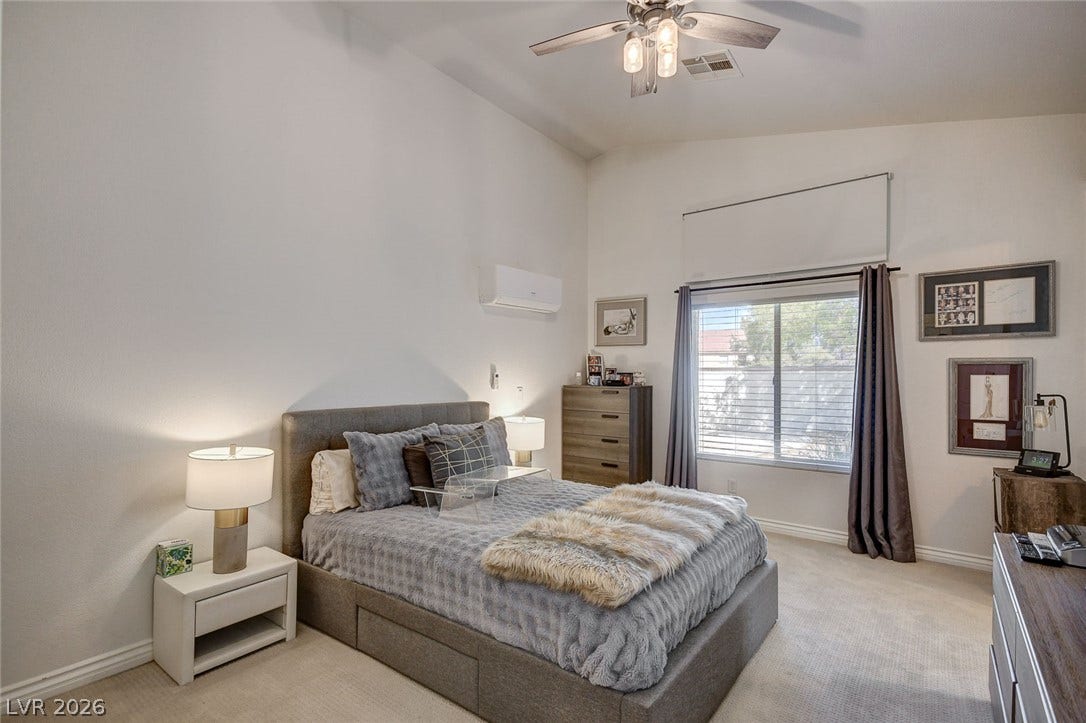 236 Misty Garden Street, Henderson, NV 89012 High vaulted ceilings and a large window create a light-filled atmosphere in this bedroom.