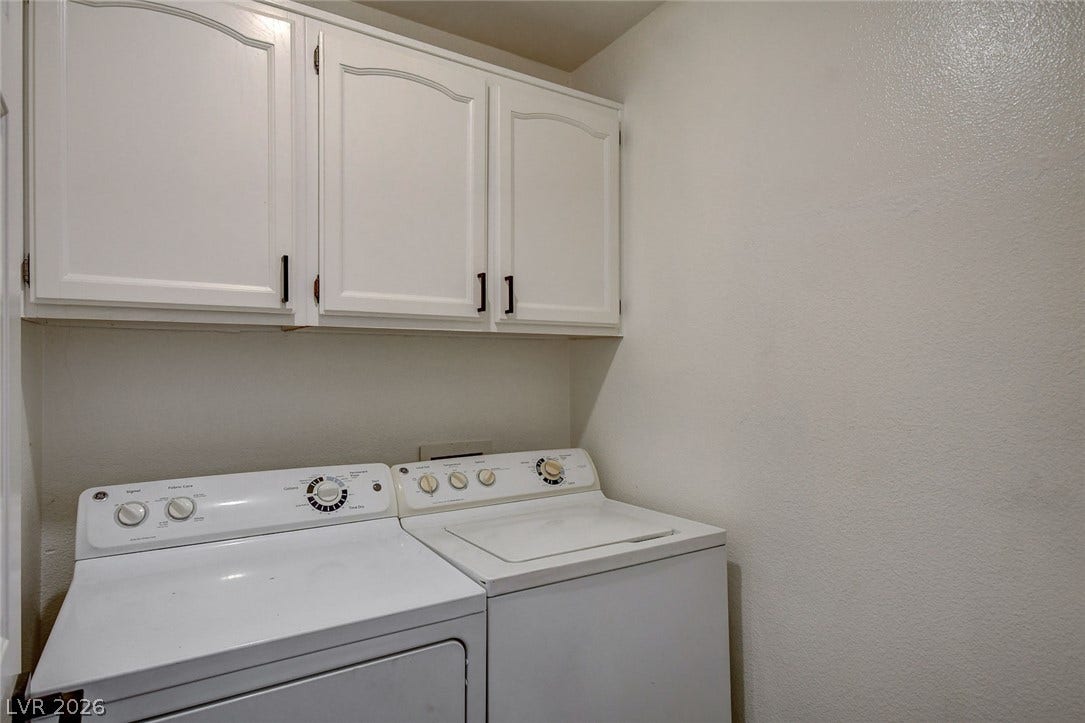 236 Misty Garden Street, Henderson, NV 89012 White cabinetry provides storage directly above the laundry appliances.