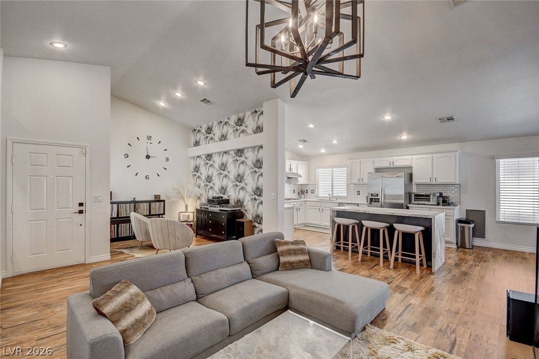 236 Misty Garden Street, Henderson, NV 89012 Gleaming hardwood floors and high vaulted ceilings define this inviting open concept living space.