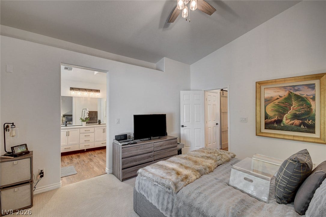 236 Misty Garden Street, Henderson, NV 89012 High vaulted ceilings and plush carpeting define this spacious primary bedroom suite.