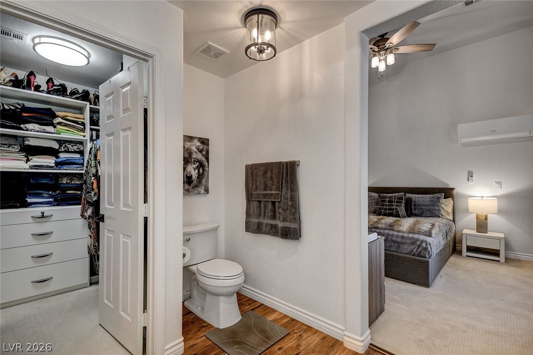236 Misty Garden Street, Henderson, NV 89012 An open floor plan connects the dressing area, washroom, and carpeted bedroom suite.