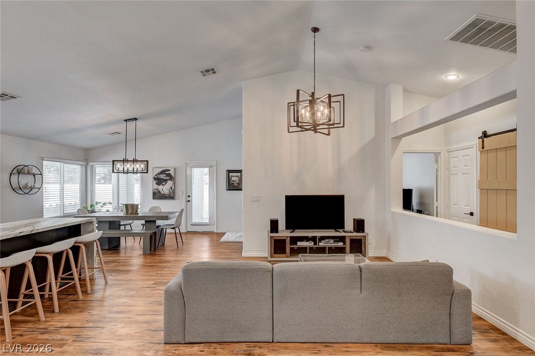 236 Misty Garden Street, Henderson, NV 89012 Vaulted ceilings and warm wood floors define this welcoming, open-concept layout.