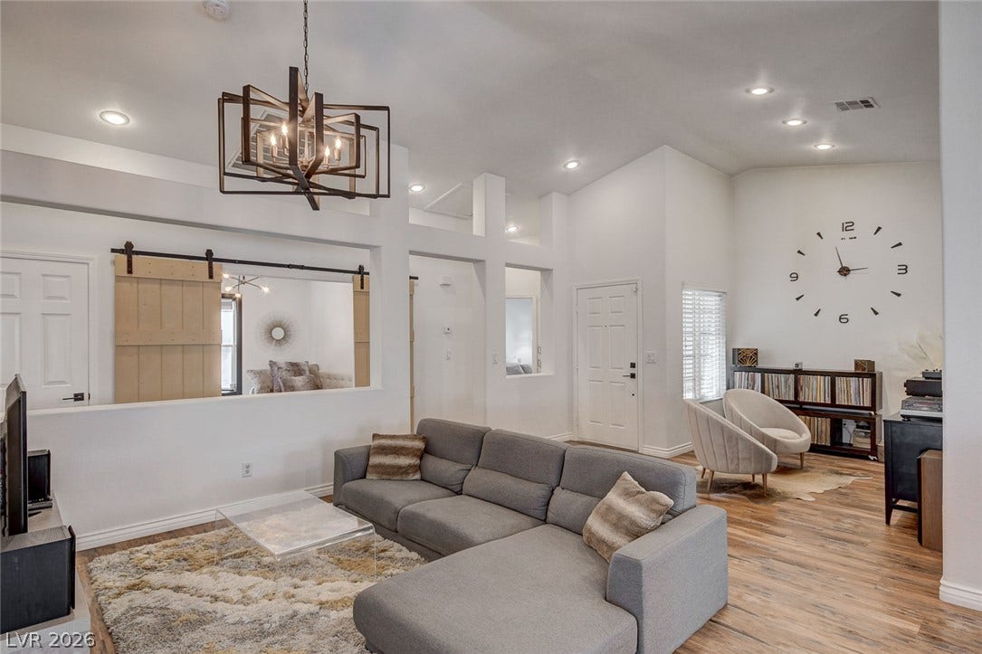 236 Misty Garden Street, Henderson, NV 89012 High vaulted ceilings and rich wood-texture flooring define this spacious living area.