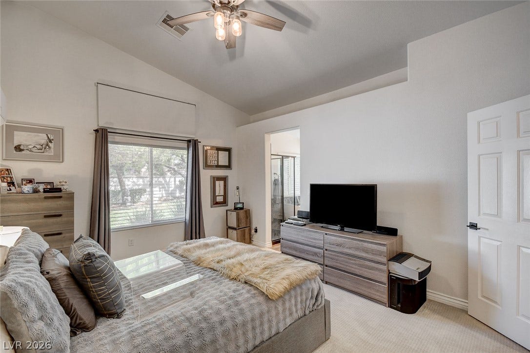 236 Misty Garden Street, Henderson, NV 89012 Vaulted ceilings and neutral carpet define this tranquil primary bedroom retreat.