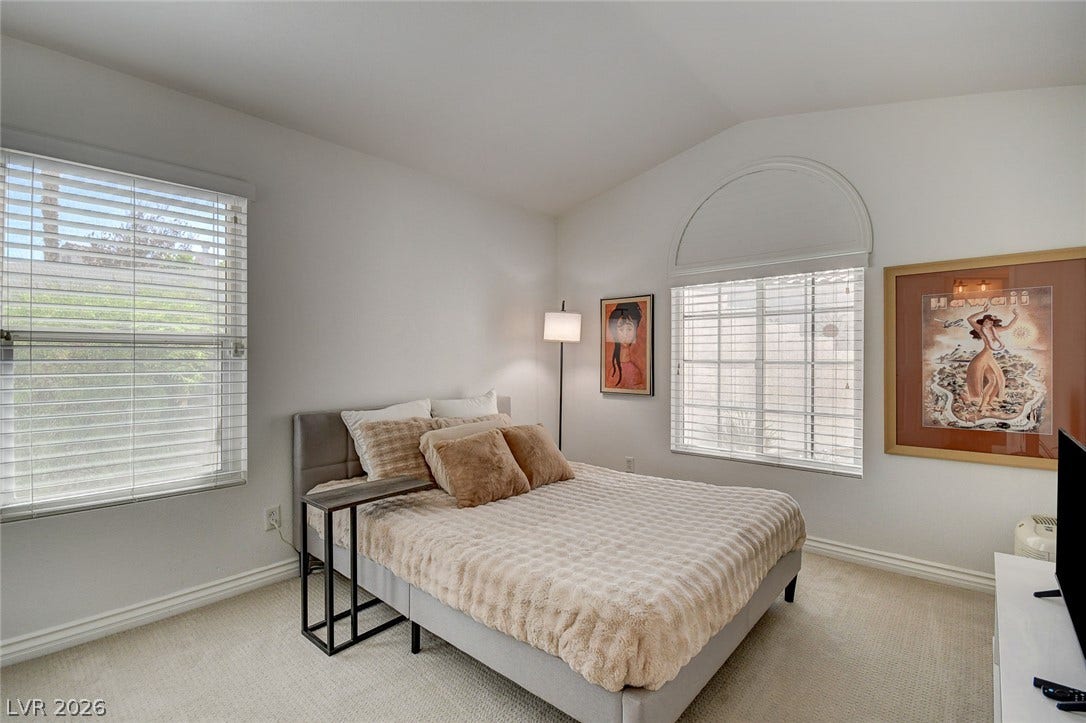 236 Misty Garden Street, Henderson, NV 89012 High vaulted ceilings and custom arched windows elevate this serene sleeping space.