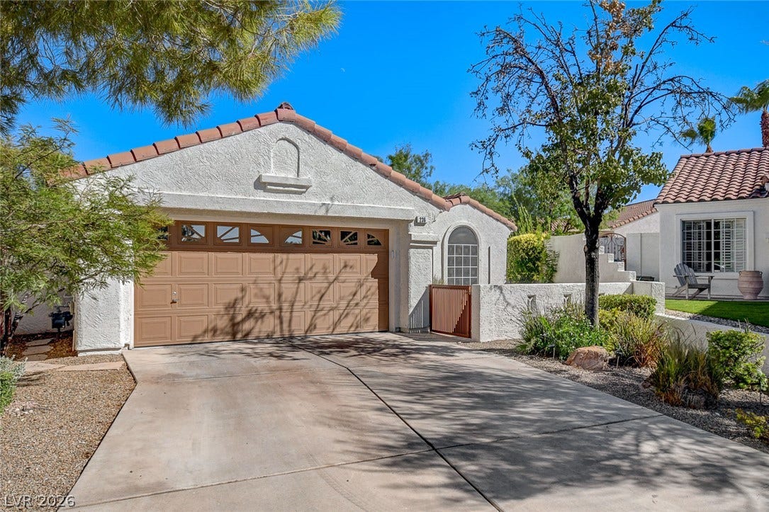 236 Misty Garden Street, Henderson, NV 89012 Clay tile roofing and a textured stucco exterior showcase classic Mediterranean-inspired architecture.