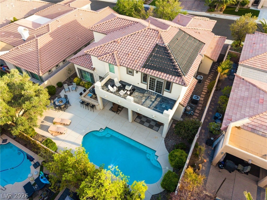 11416 Rancho Portena Avenue, Las Vegas, NV 89138 An inviting backyard oasis features a glistening swimming pool and tiled terraces.