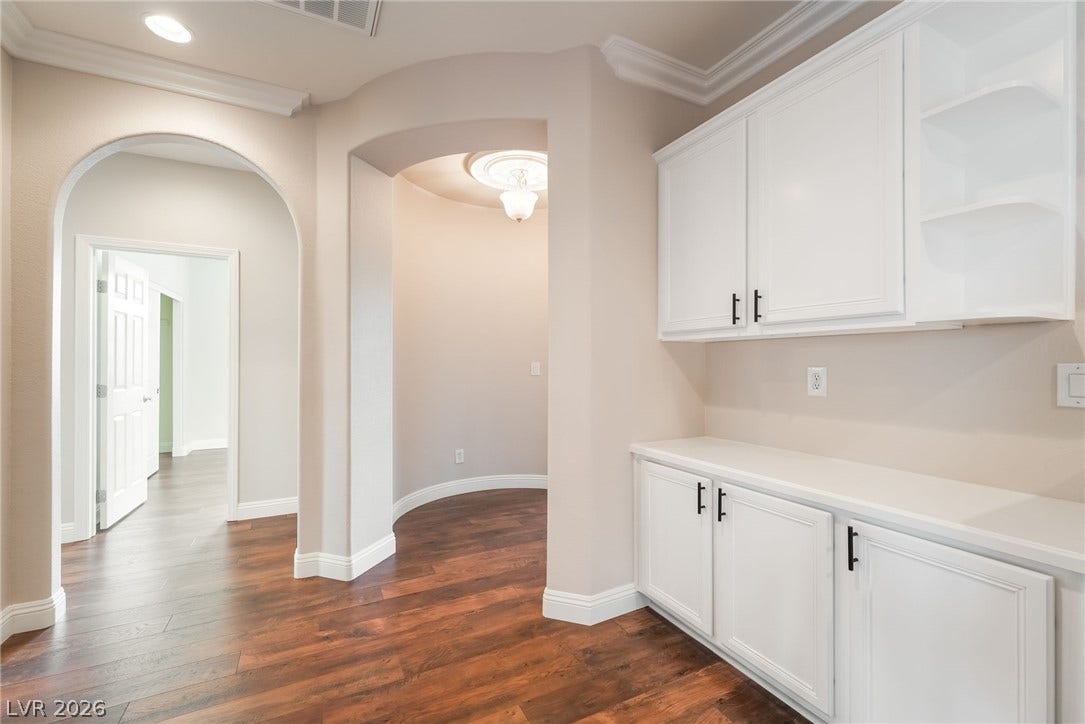 11416 Rancho Portena Avenue, Las Vegas, NV 89138 Elegant arched transitions and built-in cabinetry define this warm, light-filled hallway space.