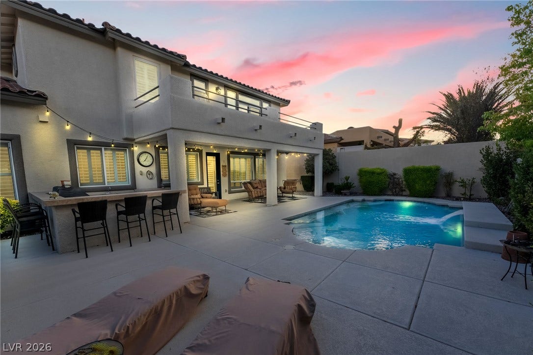 11416 Rancho Portena Avenue, Las Vegas, NV 89138 An inviting backyard oasis features a pristine swimming pool and a covered patio area.