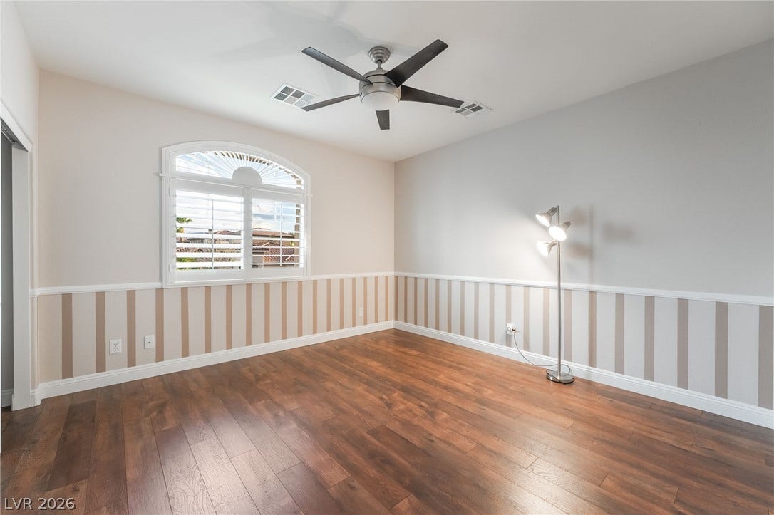 11416 Rancho Portena Avenue, Las Vegas, NV 89138 Rich hardwood floors and vertical wainscoting define this inviting space filled with natural light.