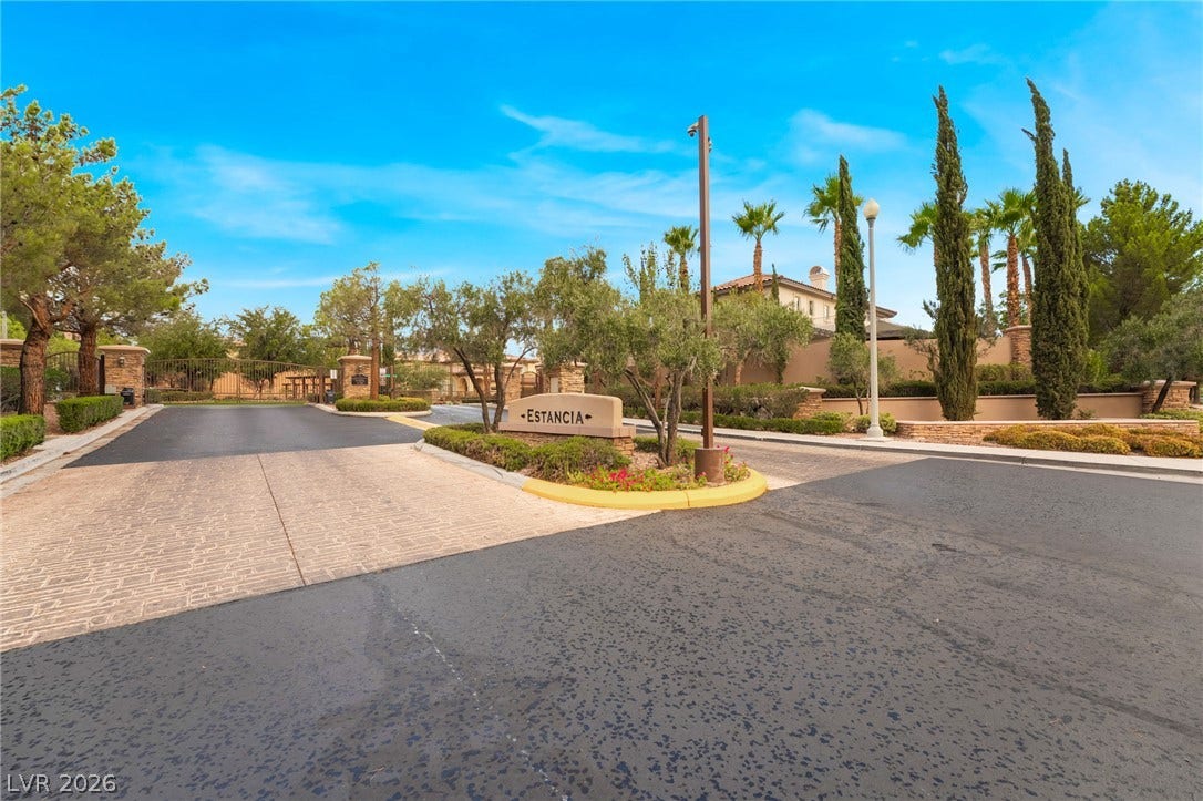 11416 Rancho Portena Avenue, Las Vegas, NV 89138 A secure gated entrance welcomes residents with manicured landscaping and a prominent stone sign.