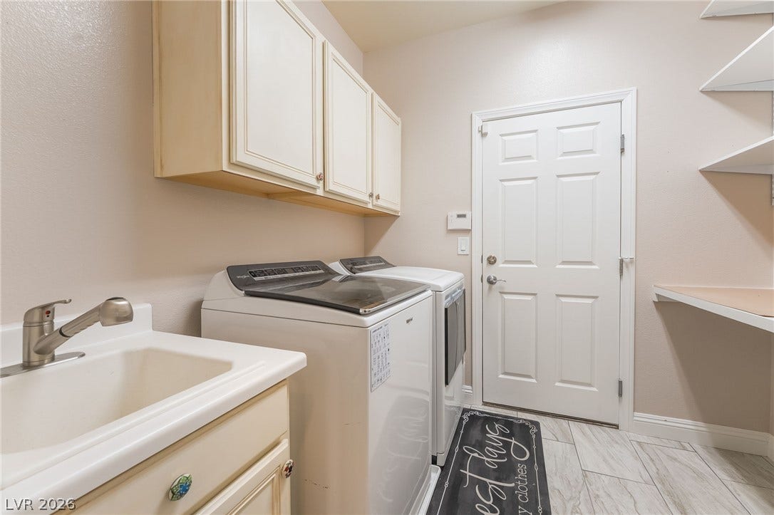 11416 Rancho Portena Avenue, Las Vegas, NV 89138 Functional workspace highlights this utility room featuring tiled flooring and upper storage cabinets.
