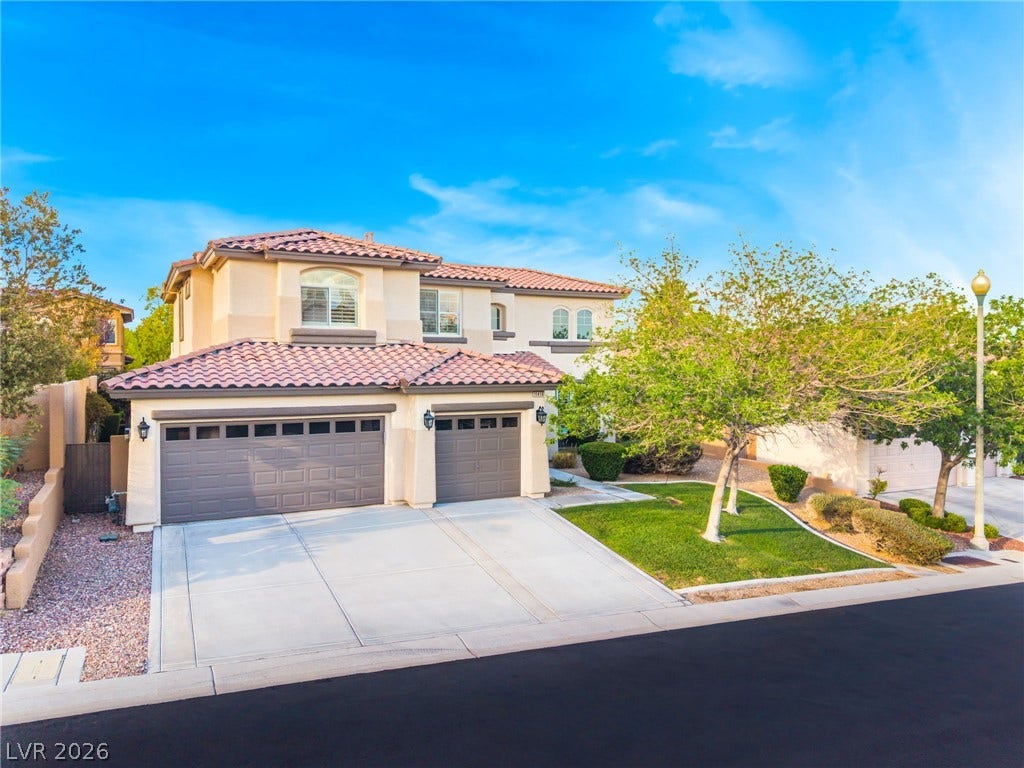 11416 Rancho Portena Avenue, Las Vegas, NV 89138 Spanish tile roofing and a wide driveway highlight this elegant multi-level exterior.