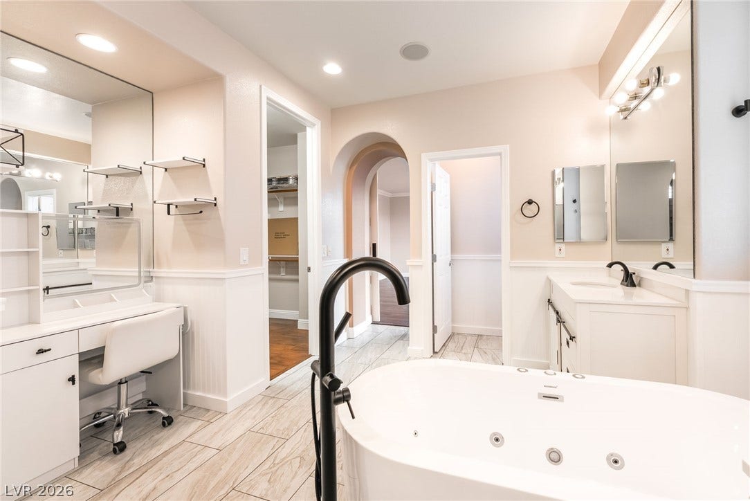 11416 Rancho Portena Avenue, Las Vegas, NV 89138 An elegant soaking tub highlights this bathroom featuring ceramic tile floors and a built-in vanity.