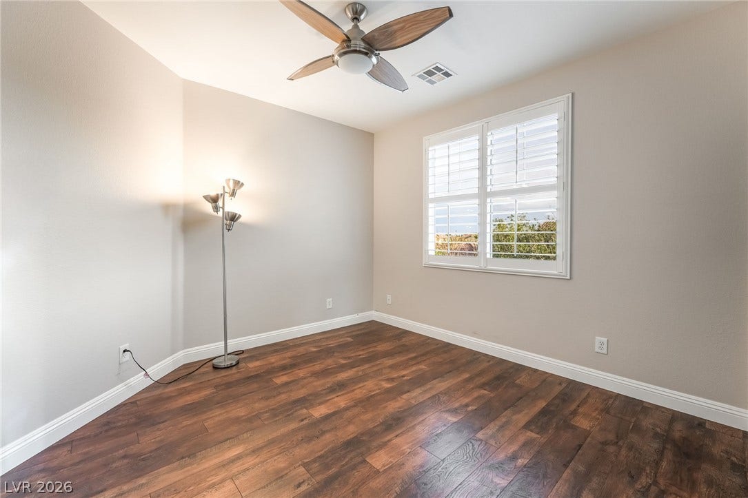 11416 Rancho Portena Avenue, Las Vegas, NV 89138 Rich wood-plank flooring and plantation shutters elevate this versatile bedroom.