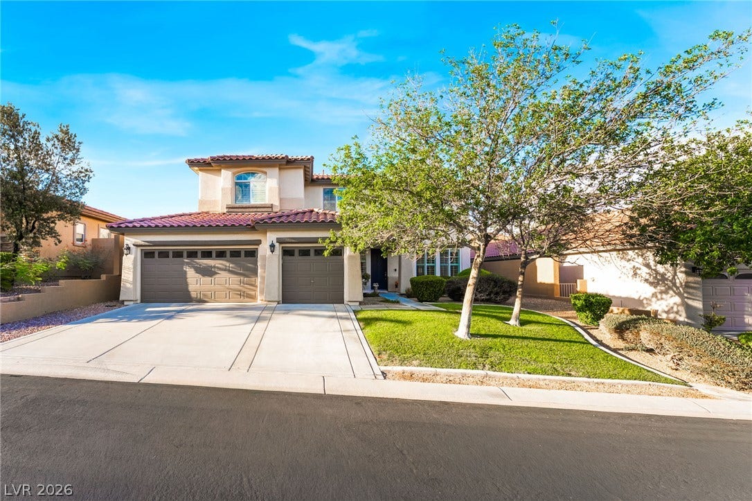 11416 Rancho Portena Avenue, Las Vegas, NV 89138 Spanish tile roofing and arched window details enhance this two-story exterior facade.