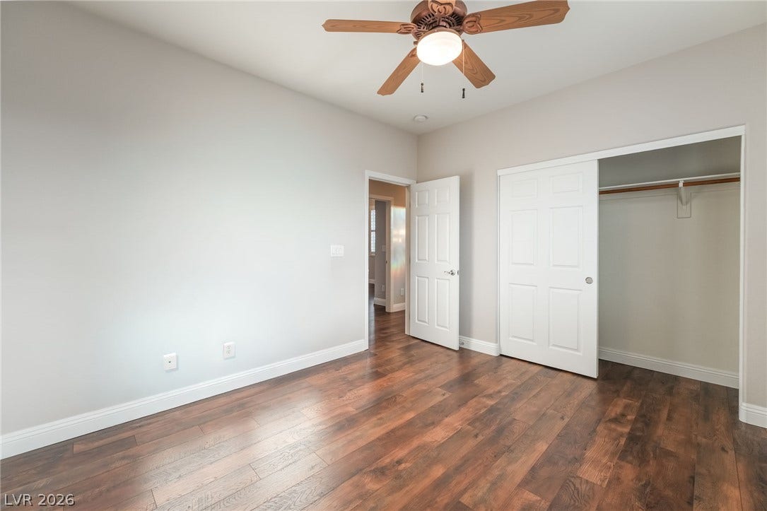 11416 Rancho Portena Avenue, Las Vegas, NV 89138 Rich wood-inspired flooring pairs with clean white trim in this versatile bedroom space.