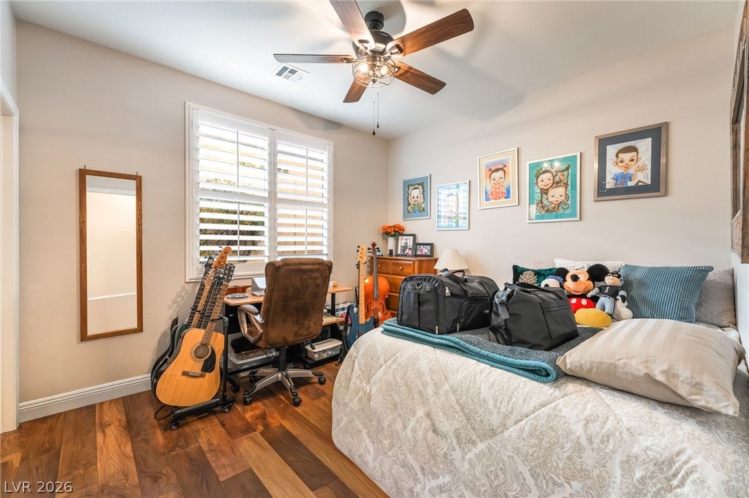 11416 Rancho Portena Avenue, Las Vegas, NV 89138 Rich hardwood flooring complements the structured window shutters in this comfortable bedroom space.