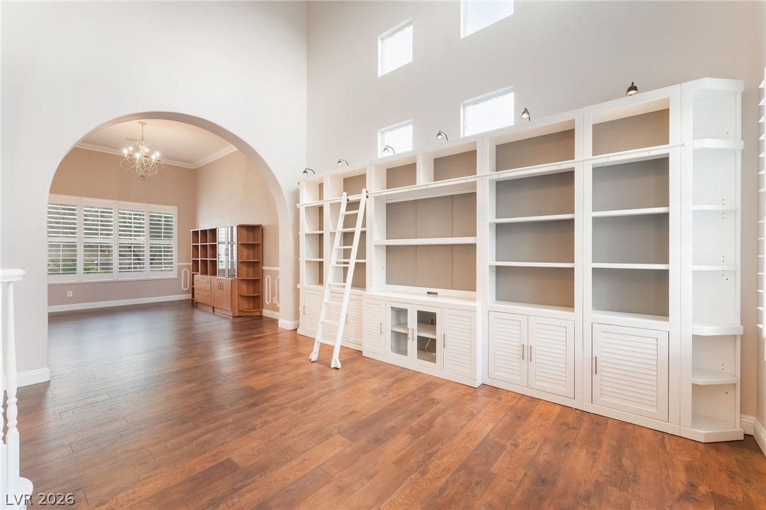 11416 Rancho Portena Avenue, Las Vegas, NV 89138 Soaring ceilings and custom built-ins define this light-filled room with warm hardwood flooring.