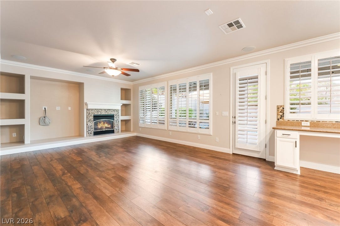 11416 Rancho Portena Avenue, Las Vegas, NV 89138 Rich wood flooring anchors this airy living space complete with a built-in fireplace.